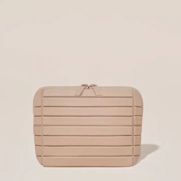Beige textured clutch bag on a beige background