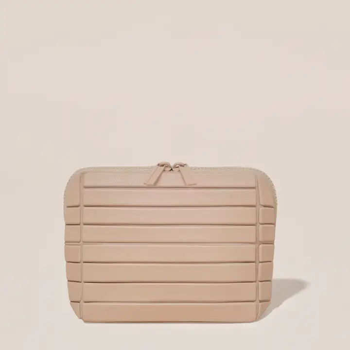 Beige textured clutch bag on a beige background