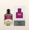 Cowgirl Grass perfume bottle and packaging on a beige background