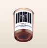 Candle with a label on a beige background
