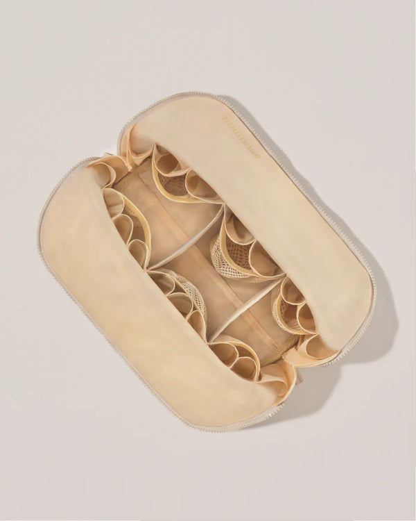 Beige jewelry case with compartments on a light gray background